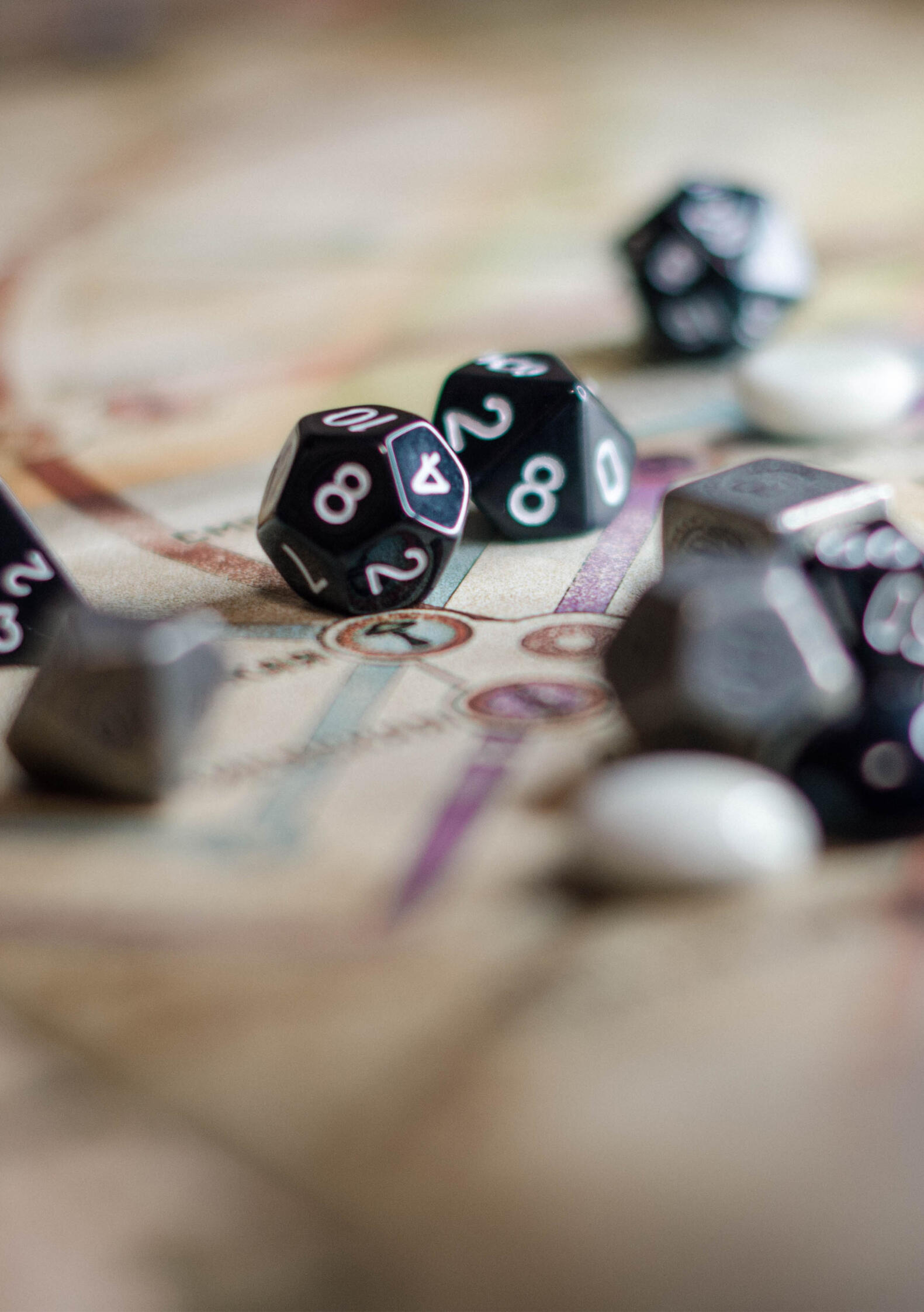 A laptop, notepad and pencil on a beige surface.